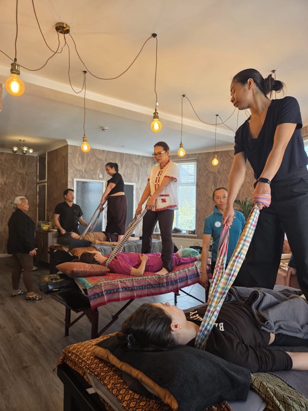 Thai massage training with traditional scarves